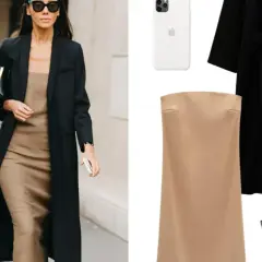 Mujer con estilo parisino, abrigo negro, vestido lencero beige, bolso negro y gafas de sol.