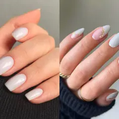 Manicura elegante con uñas blancas, algunas con detalles dorados y un toque de rosa pálido.