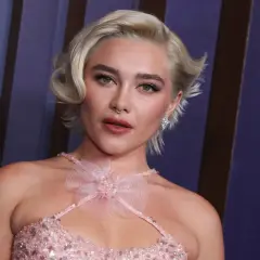 Mujer joven con corte de pelo rubio platino, estilo pixie con ondas. Un look moderno que inspira cortes de pelo corto mujer de 60 años.