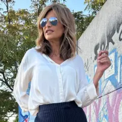 Mujer con estilo combina pantalón raya diplomática con camisa blanca. Look elegante y moderno.