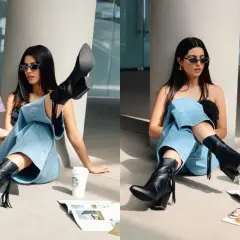 Chica con gafas de sol y jeans anchos, luciendo unas **botas en verano** mientras lee una revista junto a un café.