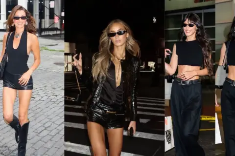 Tres mujeres con atuendos negros, una con botas de cuero y shorts, otra con chaqueta brillante y shorts, y la tercera con top corto y pantalones anchos, evocan un estilo glam rock.