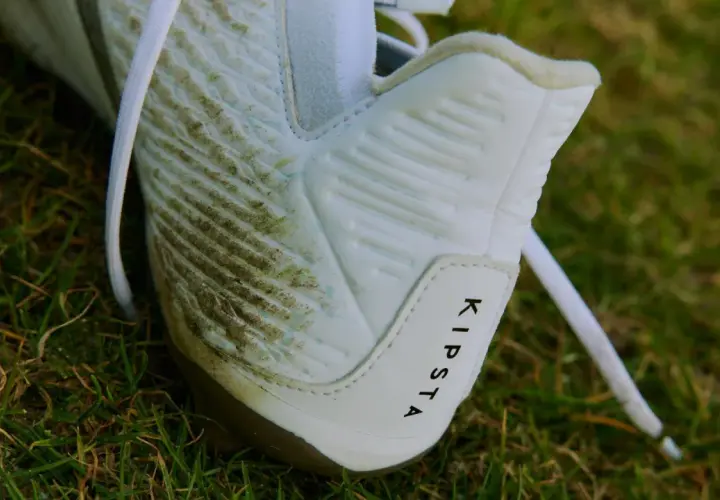 Botas de fútbol Kipsta sucias en el césped. Aprende como limpiar unas botas para dejarlas como nuevas.