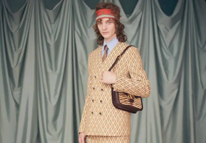 Modelo con traje estampado y bolso de cebra, un look que evoca la audacia de Alessandro Michele.