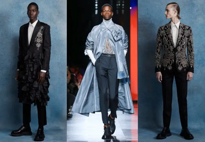 Tres modelos masculinos lucen trajes de alta costura con un aire de la época victoriana: uno con volantes negros, otro con un abrigo azul y un tercero con un traje bordado.