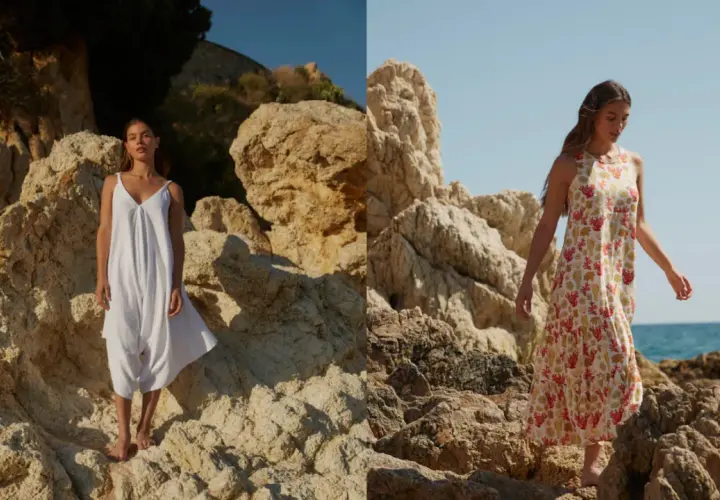 Mujer con vestido blanco y otro estampado de coral, sobre rocas. La tela viscosa que es, se ve ligera y fresca.