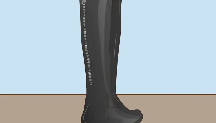 Bota alta negra con cremallera lateral, ideal para aprender como dar de si unas botas altas y lograr un ajuste perfecto.
