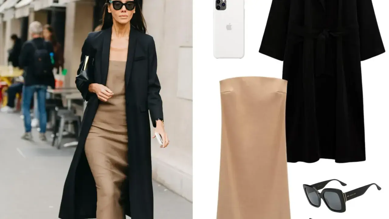 Mujer con estilo parisino, abrigo negro, vestido lencero beige, bolso negro y gafas de sol.