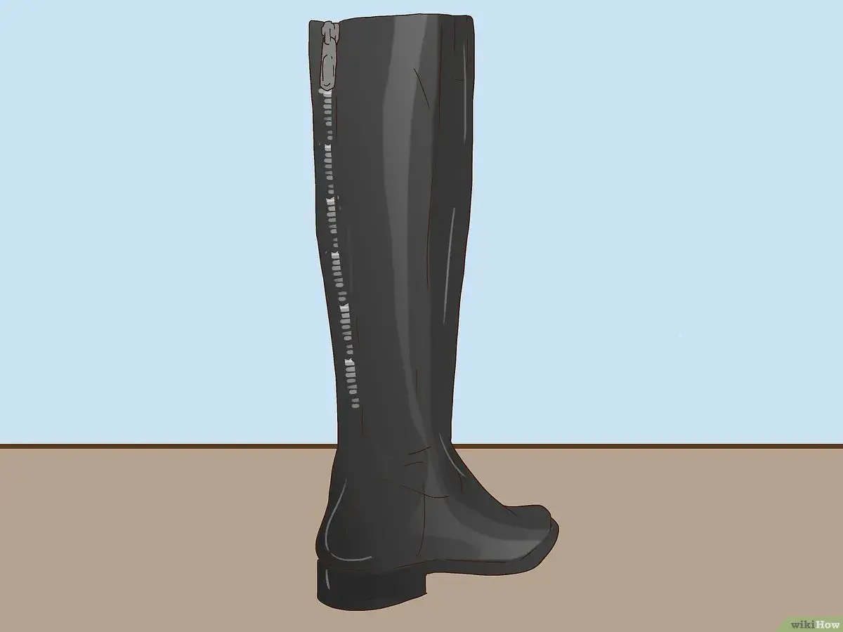 Bota alta negra con cremallera lateral, ideal para aprender como dar de si unas botas altas y lograr un ajuste perfecto.