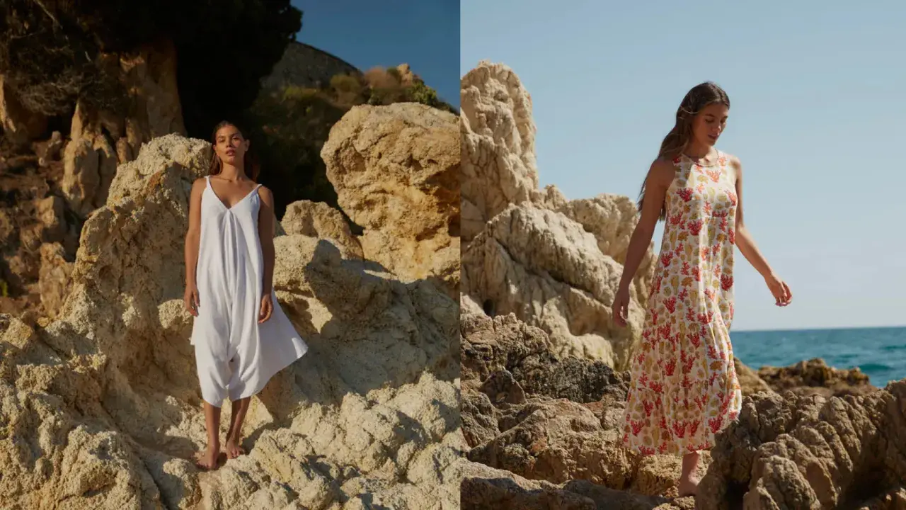 Mujer con vestido blanco y otro estampado de coral, sobre rocas. La tela viscosa que es, se ve ligera y fresca.