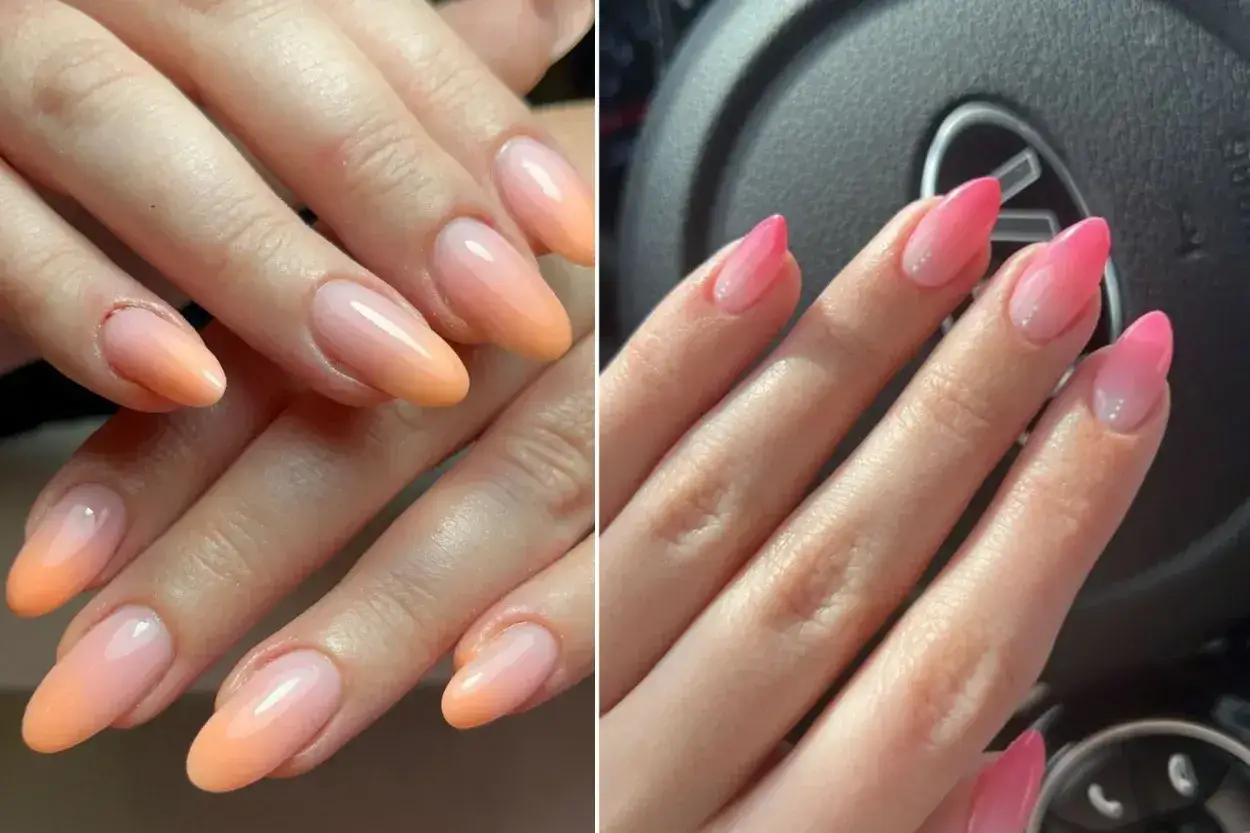 Manicura de uñas baby boomer con degradado de naranja a rosa y de rosa a blanco.