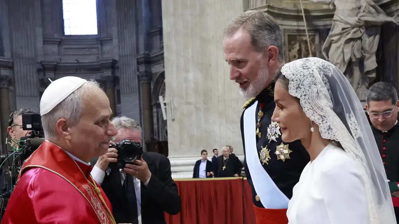 El Papa saluda a los reyes de España. Un privilegio de blanco, el Papa viste su sotana roja y solideo, mientras los reyes lucen sus atuendos ceremoniales.